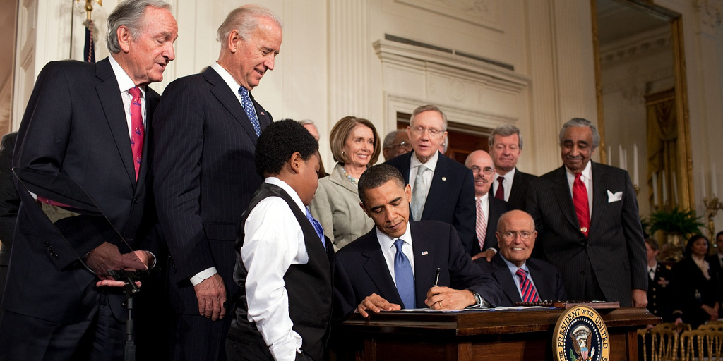 Barack Obama signs his health care reform bill