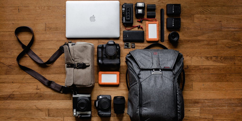 A photographer's gear is laid out on a table