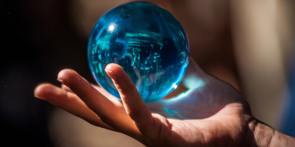 A crystal ball in a person's hand