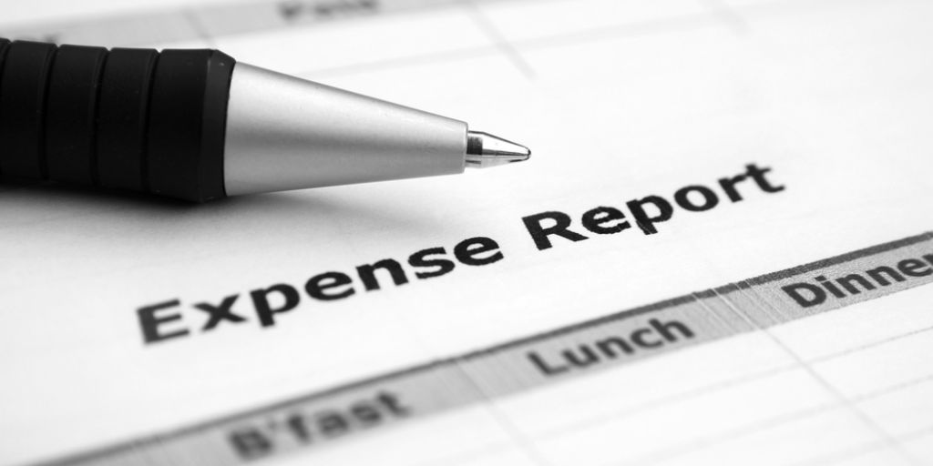 A pen on top of an expense report showing columns for meals.