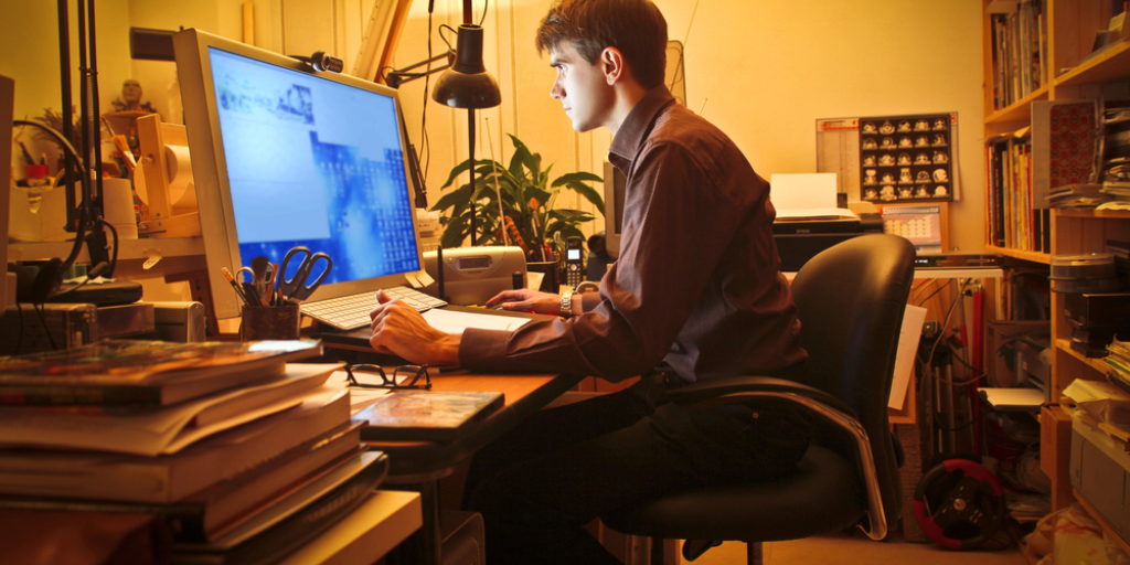 Young man at his desk using a computer