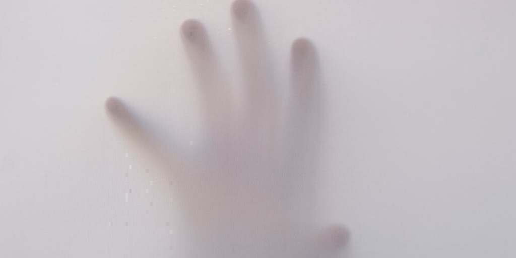A hand is shown in a foggy room
