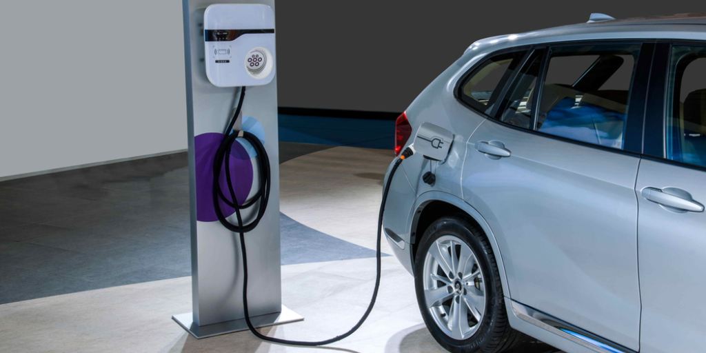 A car plugged into an electric charging station