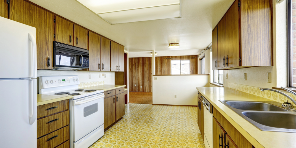 A kitchen with old-fashioned floors and cabinets