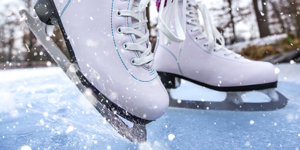 Close-up of ice skates on a frozen pond