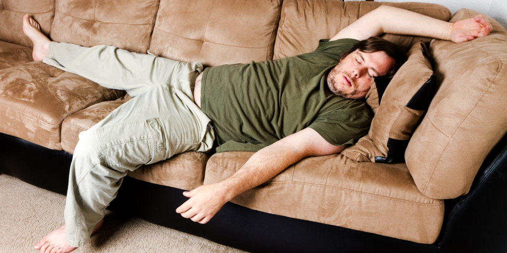 A disheveled man sleeping on the couch: a perfect example of someone who might be overstaying his welcome.