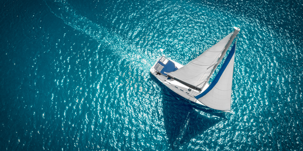 Aerial view of a sailboat in windy conditions.