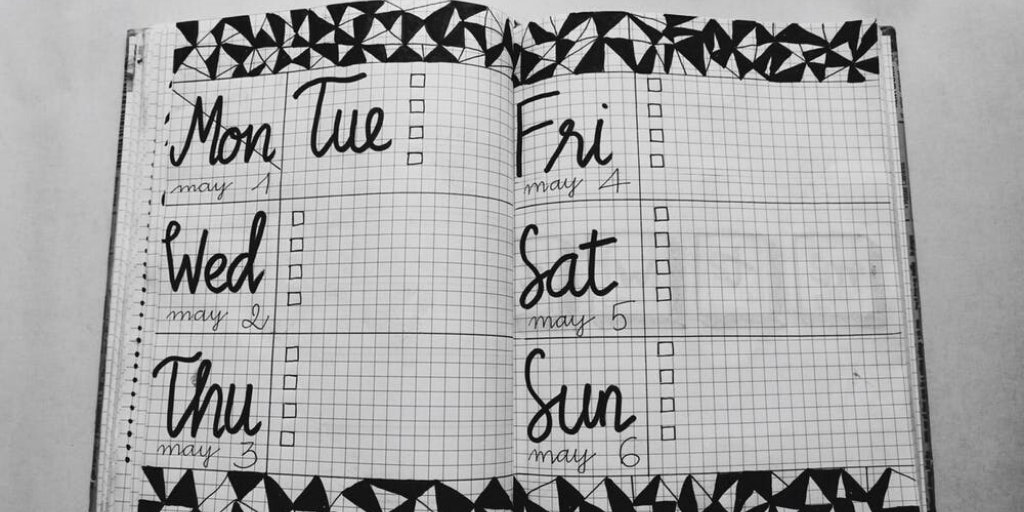 A notebook shows an empty diary for an entire week