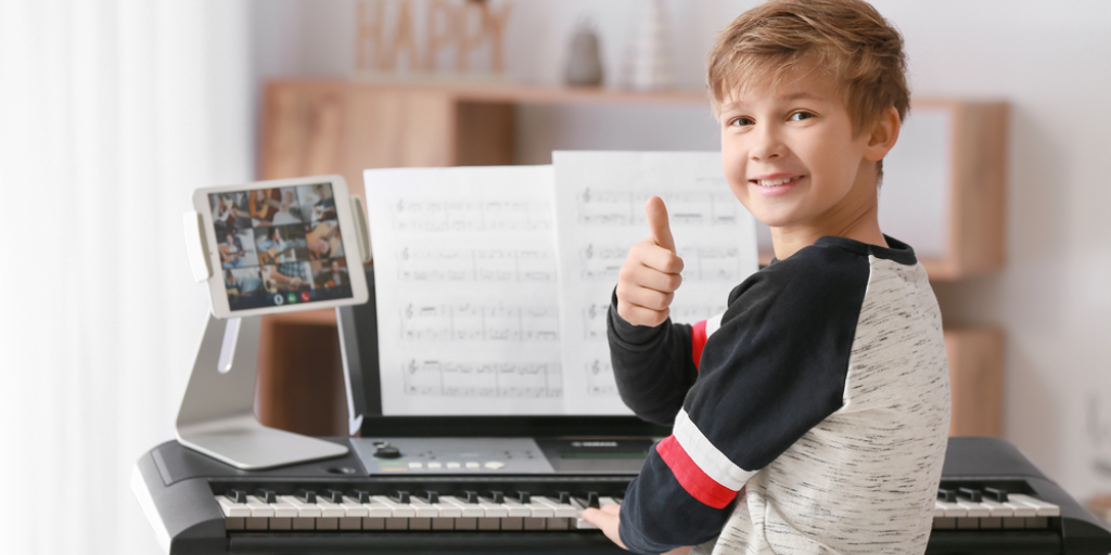 A boy in front of a musical keyboard