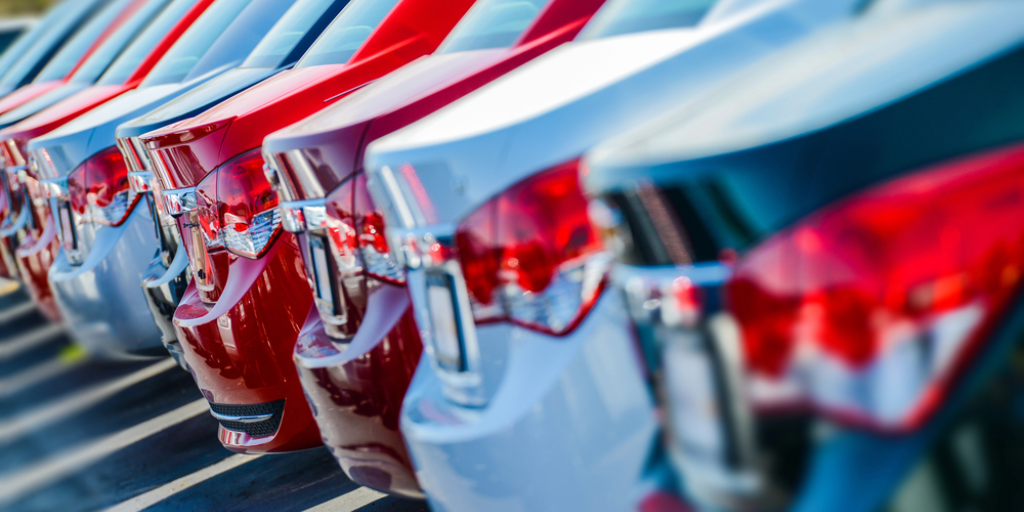 A line of new cars on a dealer's lot