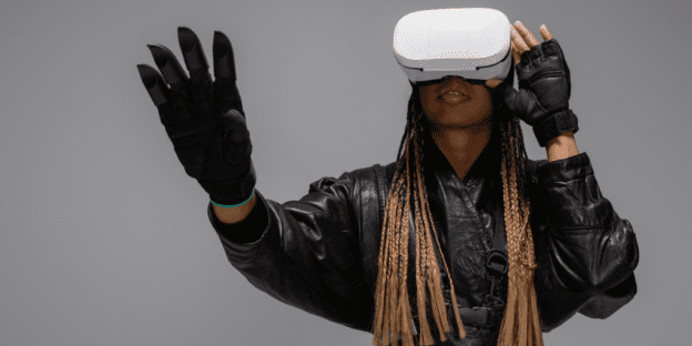 A woman is wearing virtual reality goggles. You have our permission to write off the metaverse.