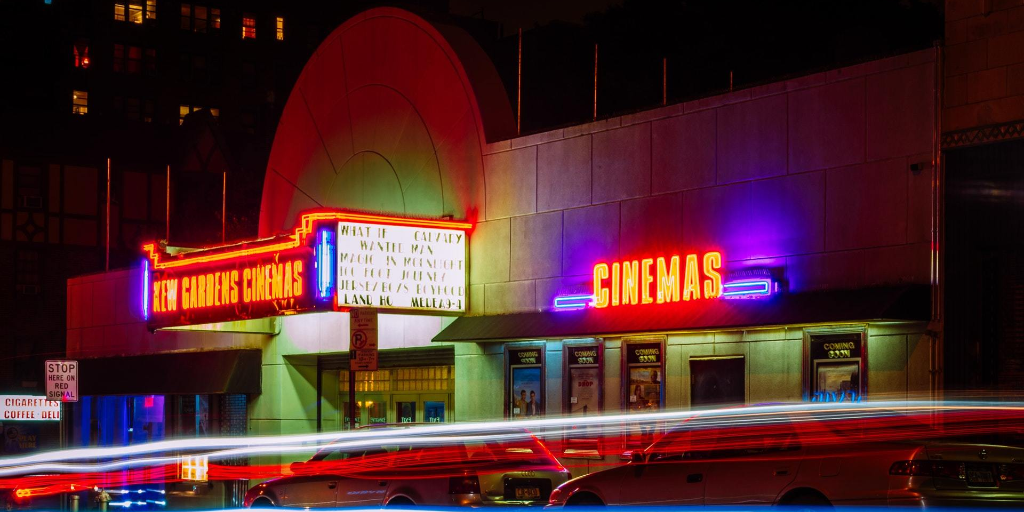 An exterior view of a movie theater at night