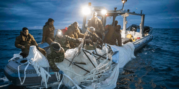U.S. Navy personnel recover the Chinese balloon after it was shot down over the Atlantic Ocean.
