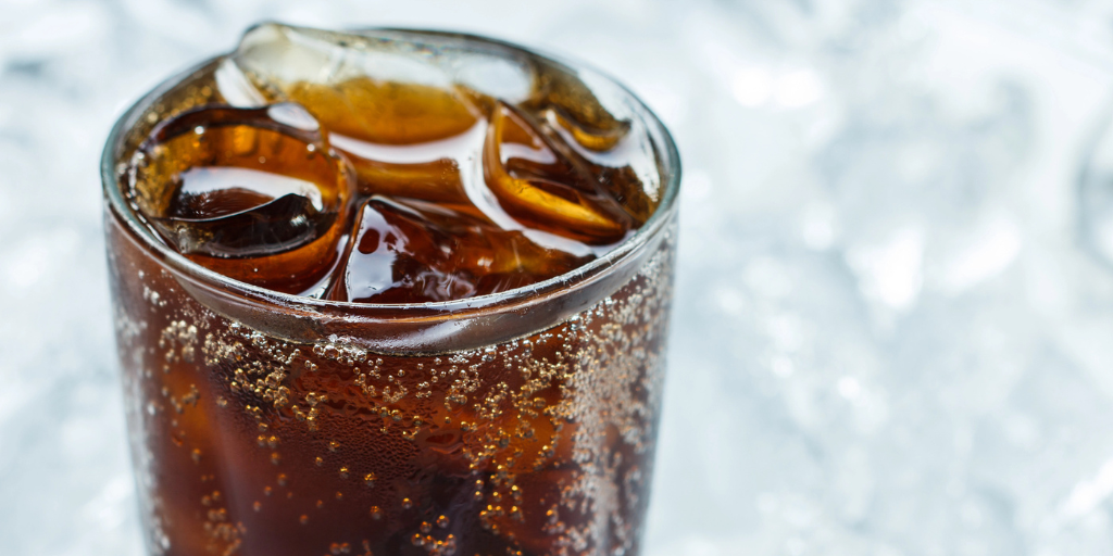A glass of cola with ice cubes