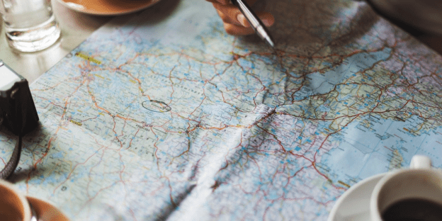 A wrinkled map is spread out on a desk