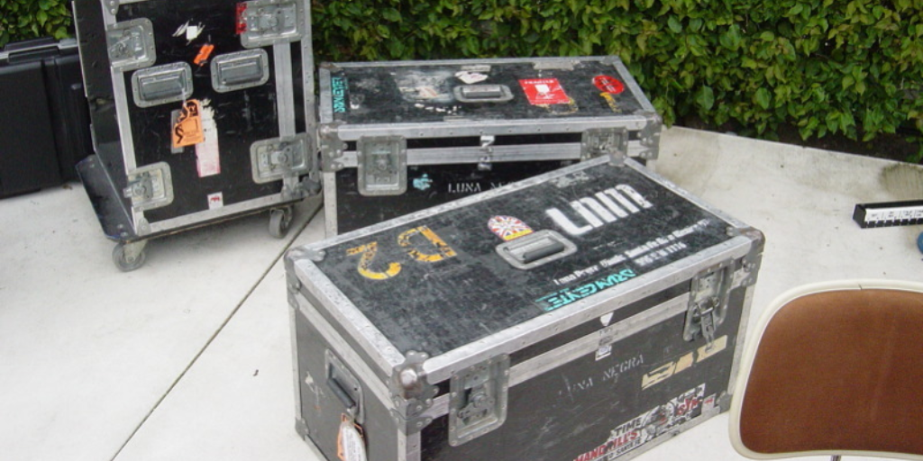 Three black cases used to transport audio equipment or