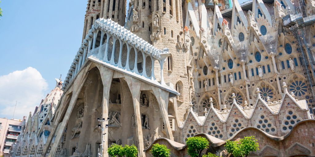 A close up of one façade of the Sagrada Familia in summertime