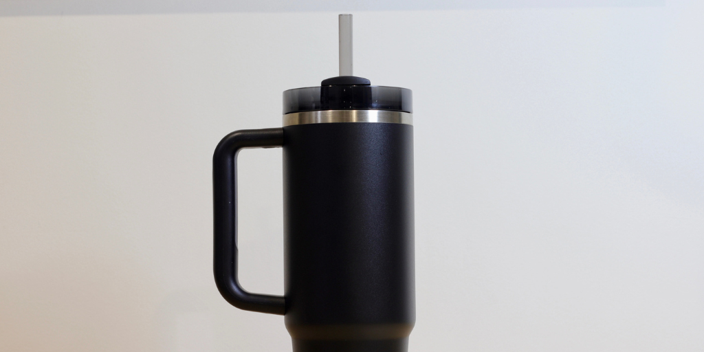 A designer black water bottle, similar in style to a Stanley