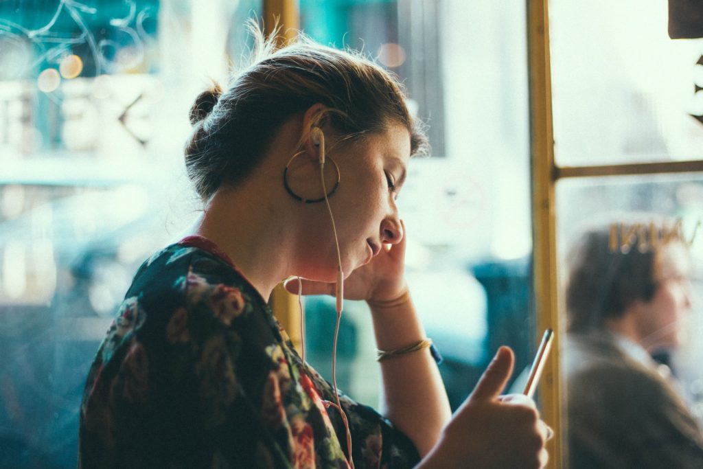 Woman listening to music on public transit.