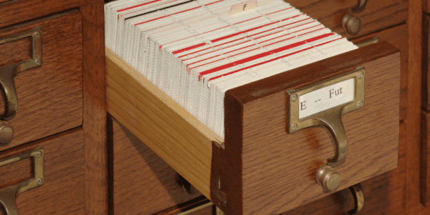 A card catalog with one drawer open.