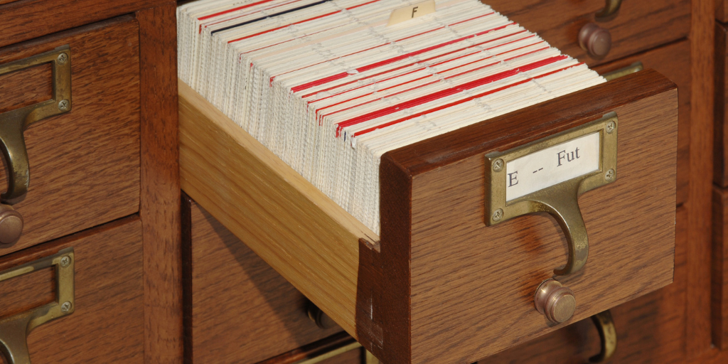 A card catalog with one drawer open.